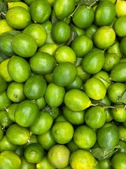 Fresh ripe green limes as background. Lime Citrus Fruits In Fruit Market