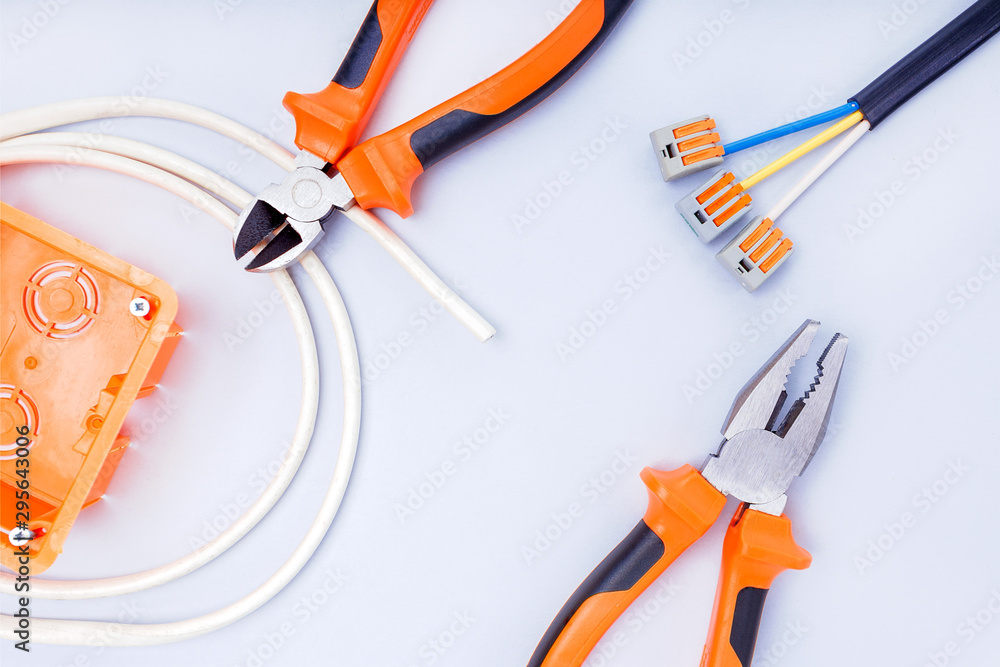 Wall mural different electrical tools on grey background. top view.