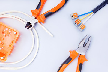 Different electrical tools on grey background. Top view.
