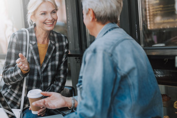 Two coworkers talking in a street cafe