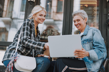 Ladies looking at the screen of a laptop