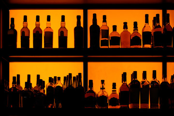 Fototapeta Bottles sitting on shelf in a bar obraz
