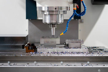 High precision CNC machining center working, operator machining automotive sample part process in...