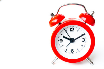 close up of a vintage red bell clock on white background