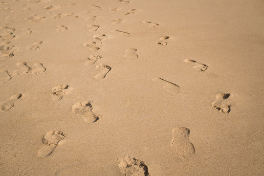 Footsteps on the sand beach background