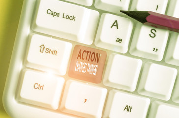 Writing note showing Action Changes Things. Business concept for start doing something against...