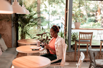 Young woman with camera in restaurant stock photo