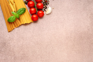 Pasta ingredients on light rustic background with copy space