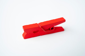Red wooden clothespins on a white background.