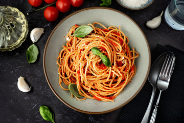 Close up of spaghetti with tomato sauce on black background - obrazy, fototapety, plakaty