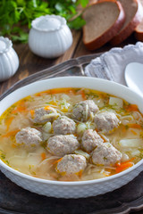 Homemade meatball and noodles soup, selective focus