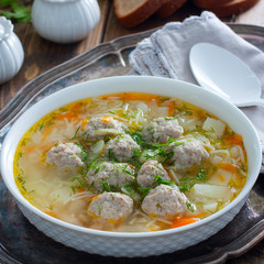 Homemade meatball and noodles soup, selective focus