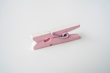 Pink wooden clothespins on a white background.