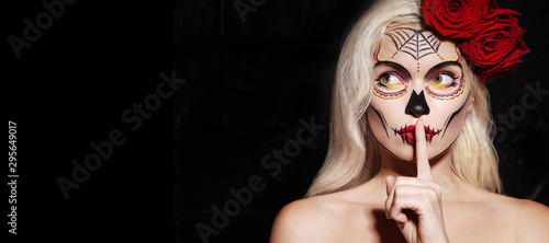 Beautiful Halloween Make-Up Style. Blond Model Wear Sugar Skull Makeup with Red Roses. Santa Muerte concept