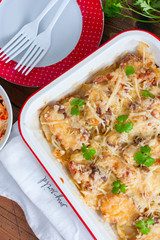 Baked sliced potatoes with pork and cheese, top view, selective focus