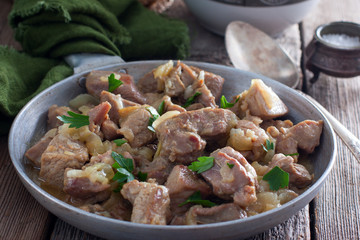 Sliced turkey thigh fillet meat on a wooden table, horizontal