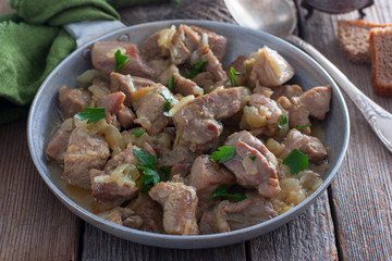 Sliced turkey thigh fillet meat on a wooden table, horizontal