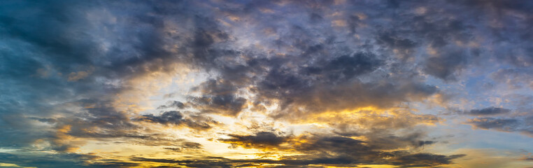 Naklejka na ściany i meble Golden hour cloudy sky panoramic nature background