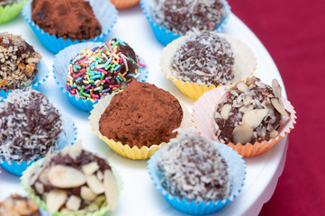 Cocoa and sesame balls with almond flakes and sprinkle