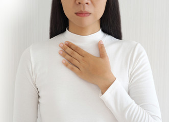 gastroesophageal reflux disease or GERD breathing difficulty in asian woman. She use hand touching chest on isolated white background use for health care concept.