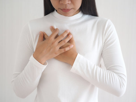 heart failure in woman and she press her chest symptom of pain and suffering cause of arrhythmia and bradycardia use for medicine product and health care concept on white background.