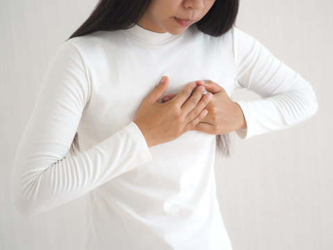 heart failure in woman and she press her chest symptom of pain and suffering cause of arrhythmia and bradycardia use for medicine product and health care concept on white background.
