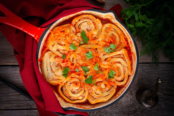 Homemade dish of dough and minced meat loaders, top view, selective focus