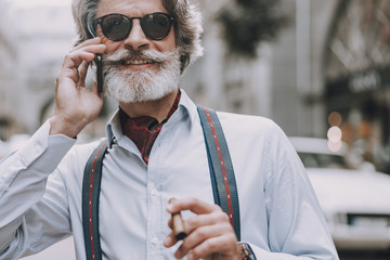 Smoking and talking on the phone outdoors stock photo