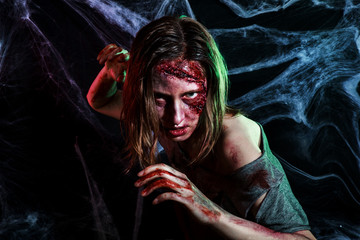 portrait of horrible zombie woman with wounds. Horror. Halloween make-up and costume