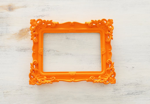 blank orange photo frame over white background. Ready for photography montage. top view flat lay