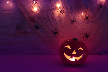 holidays halloween concept image. Pumpkin, spiders over wooden table