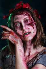 Close-up portrait of horrible zombie woman with wounds. Horror. Halloween poster. The shouting...