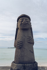 Dol Hareubang on Geumneung   beach with sea behind it