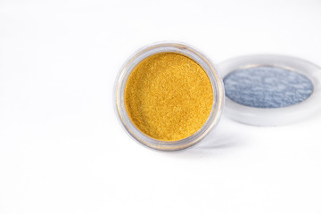 Gold and blue eye shadows  isolated on white background. Concept of makeup and beauty.