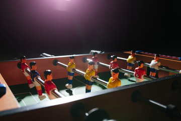Foosball table soccer. Sport team football players