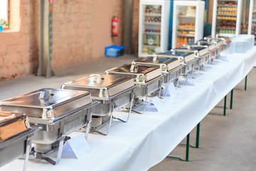 At a business conference or wedding organized hot meals. Kitchen utensils are heated on Autonomous gas burners