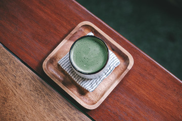 Hot Organic Matcha Green Tea in japanese cup on wooden table