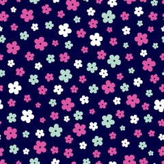 Fototapeta na wymiar Vector seamless pattern of small ditsy print flowers in hot pink, white and mint green on a dark navy blue background. Great for dressmaking fabric, bedroom decor and wallpaper.