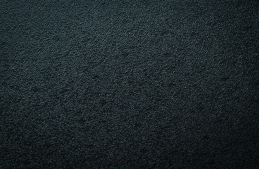 Close-up of black gray plastic material seamless texture. Surface of rough abstract dark black...