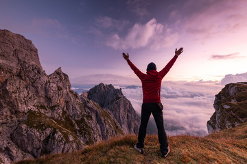 Happy Active Man at High Mountains Peak at Sunrise