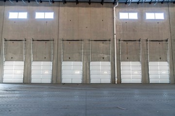 Abandoned warehouse with overhead garage doors in a row