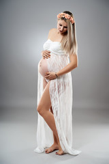 Pregnant young woman studio portrait