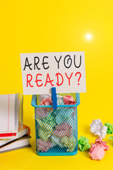 Conceptual hand writing showing Are You Ready Question. Concept meaning used telling someone start something when feel prepared Trash bin crumpled paper clothespin office supplies yellow