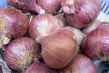 close view of red onions in a basket