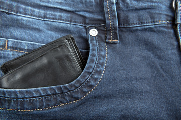 Black leather male wallet in jeans pocket