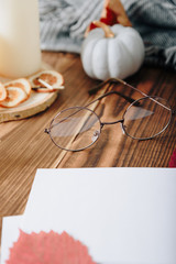autumn set of pumpkins and dried leaves on a wooden background