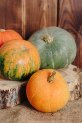 autumn set of pumpkins and dried leaves on a wooden background