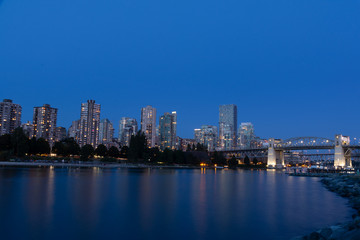 Fototapeta na wymiar Vancouver downtown with Burrard Street Bridge and Sunset Beach Park at dusk, Canada