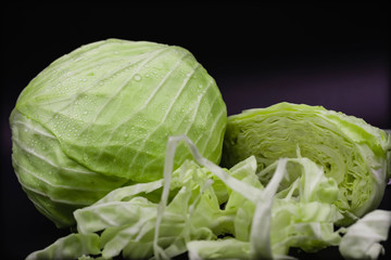 Fototapeta premium Green cabbage, isolated on a black background