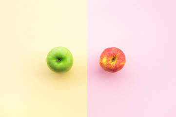 Red and green apple on pastel color desk table background.fruit and healthy, dieting concepts idea